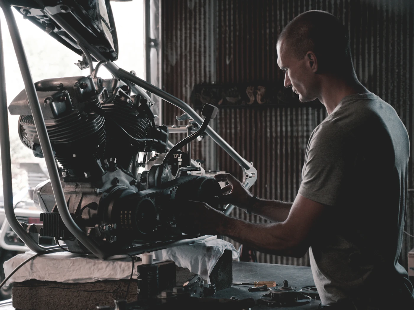 A technician working under the hood of a car